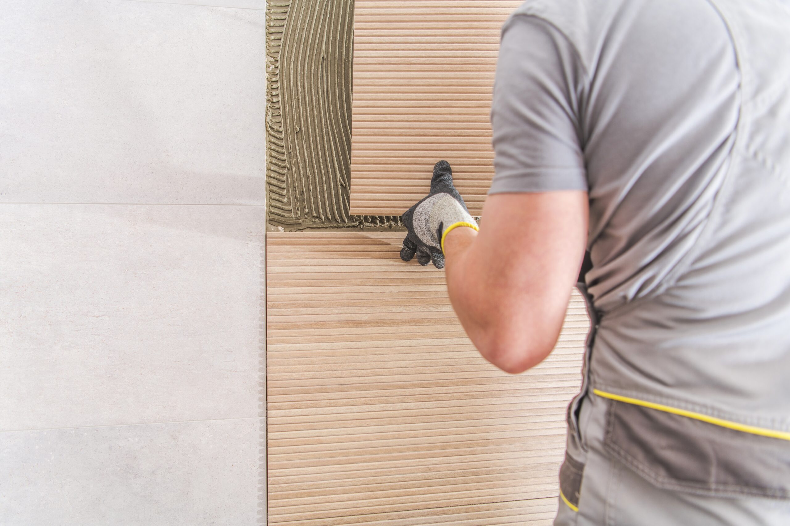 Tile adhesive installation on wall surface