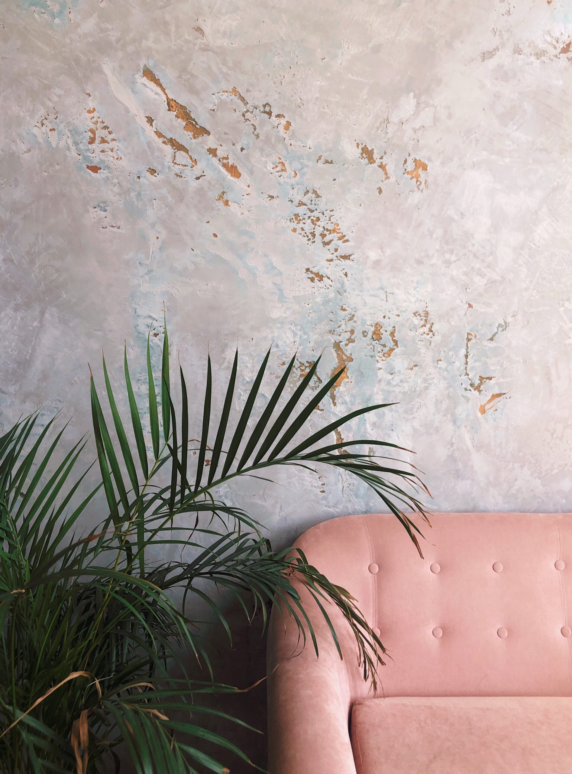 Artisan applying decorative textured plaster finish on wall